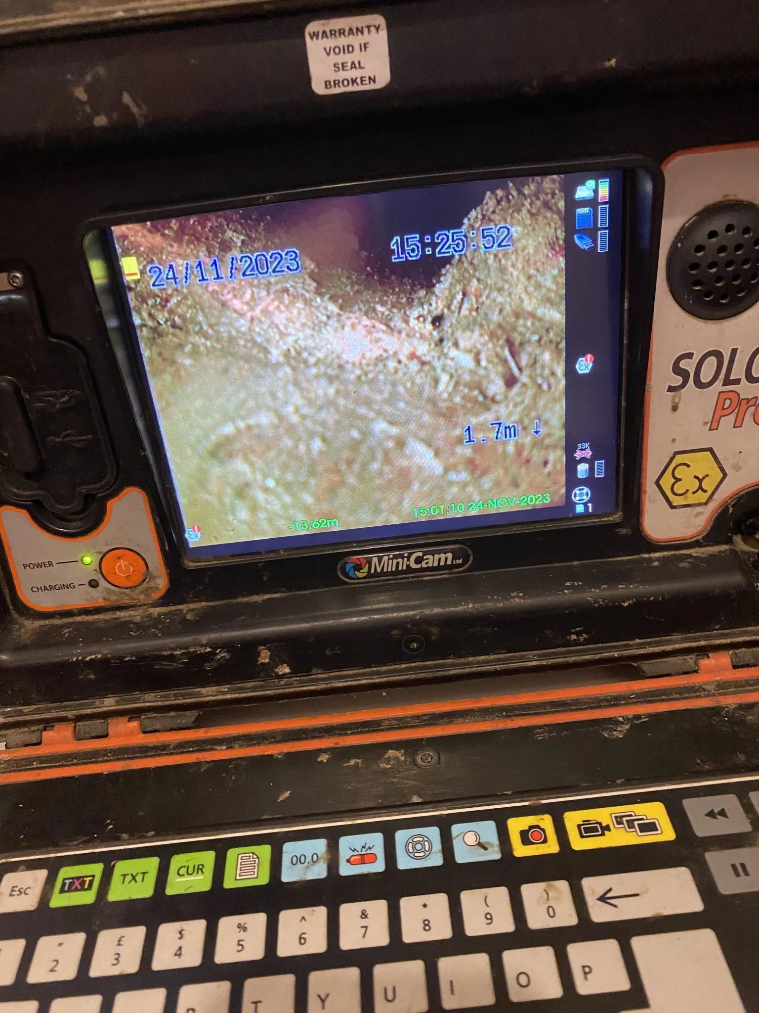 Screen showing CCTV drain survey footage inside a pipe