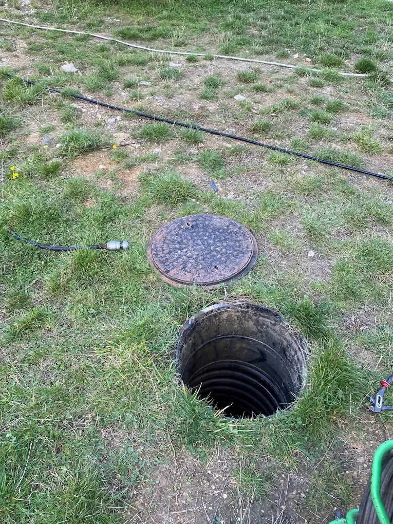 Professional drainage engineer accessing manhole for inspection or clearing work in North Yorkshire.